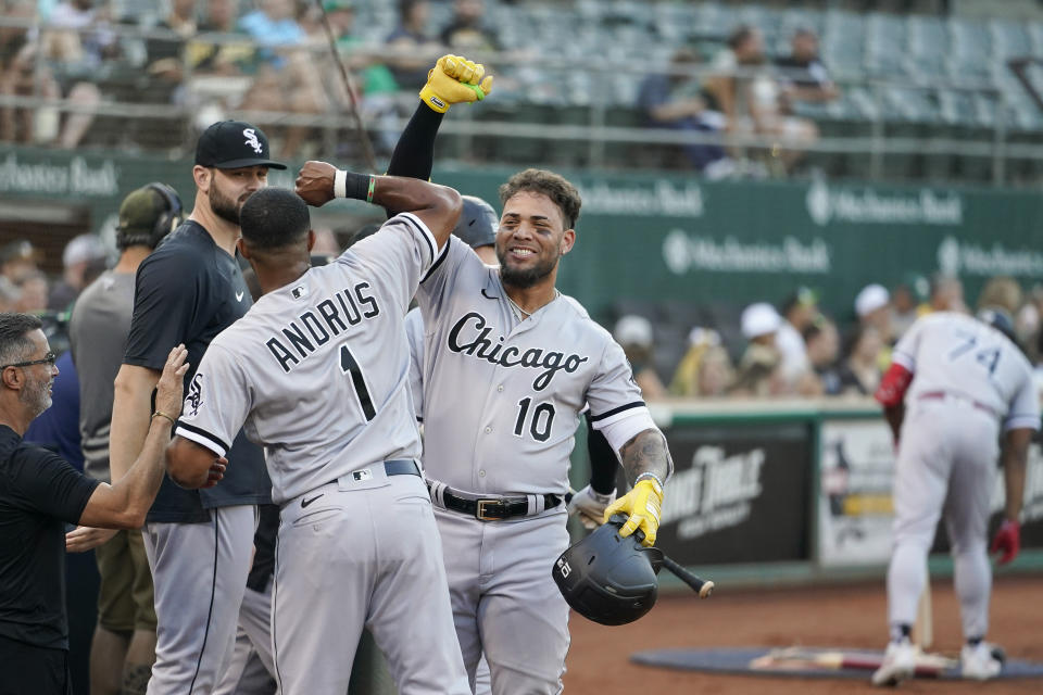Chicago White Sox's Yoán Moncada (10) celebrates with Elvis Andrus (1) after hitting a solo home run against the Oakland Athletics during the first inning of a baseball game in Oakland, Calif., Thursday, Sept. 8, 2022. (AP Photo/Godofredo A. Vásquez)