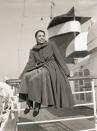 <p>Lena Horne bundles up while sailing on the SS America during the holidays. Glimpses of the singer's velvet skirt can be seen under her high-collared overcoat, as she sails to New York for Christmas with her family. </p>