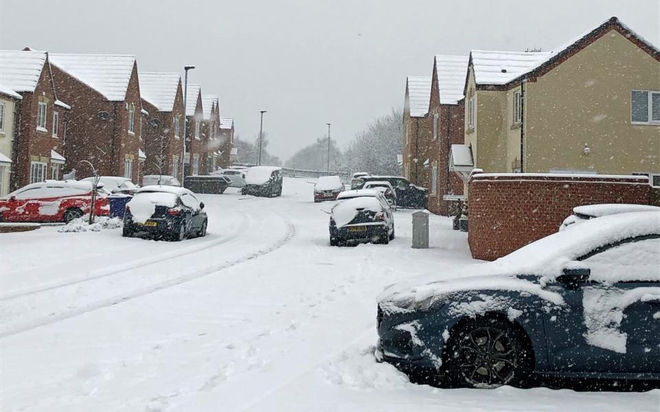 Snow covers a road in Monk Bretton, Barnsley - PA