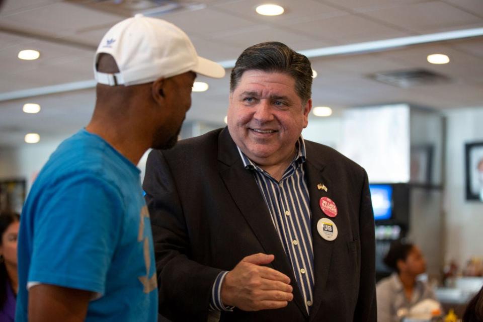 JB Pritzker talking to a man