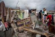 <p>A sign in French announcing a music concert sits among salvaged clothes drying on the remains of a home destroyed by Hurricane Matthew in Port-a-Piment, Haiti, Monday, Oct. 10, 2016. (AP Photo/Rebecca Blackwell)</p>