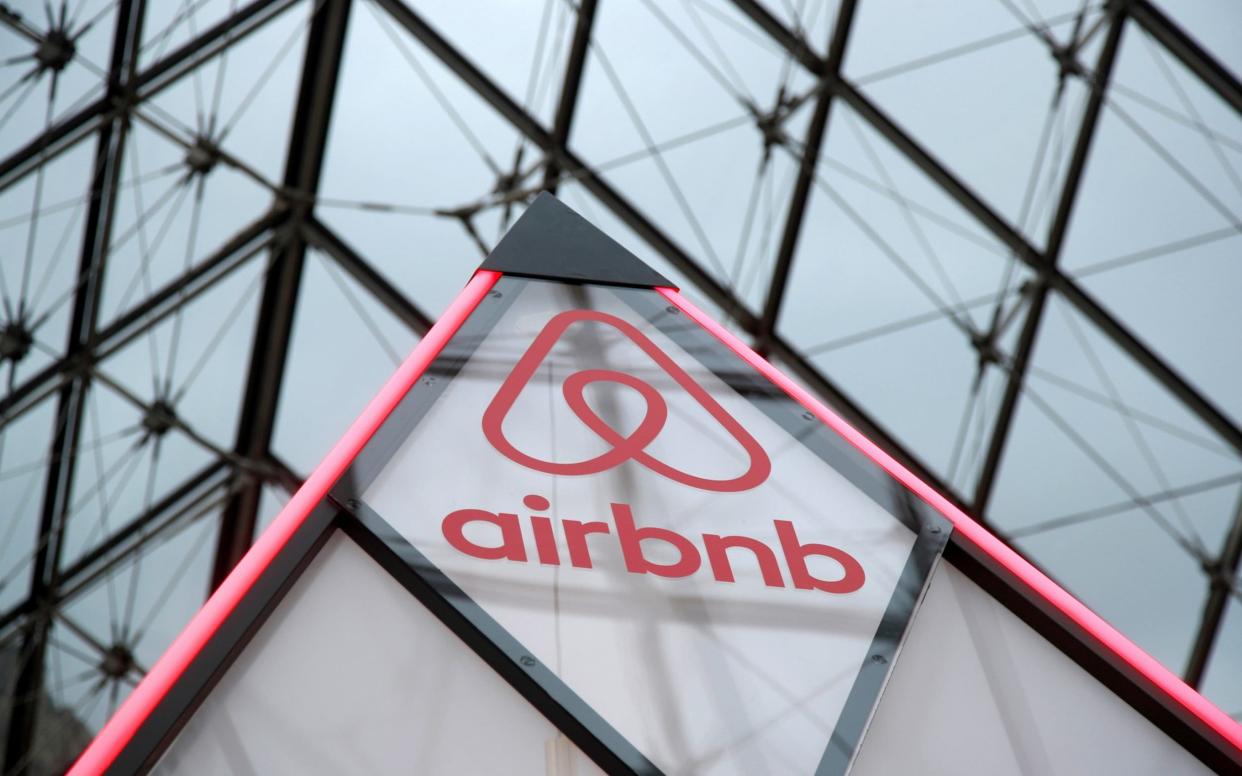  Airbnb logo is seen on a little mini pyramid under the glass Pyramid of the Louvre museum in Paris - Charles-Platiau/Reuters