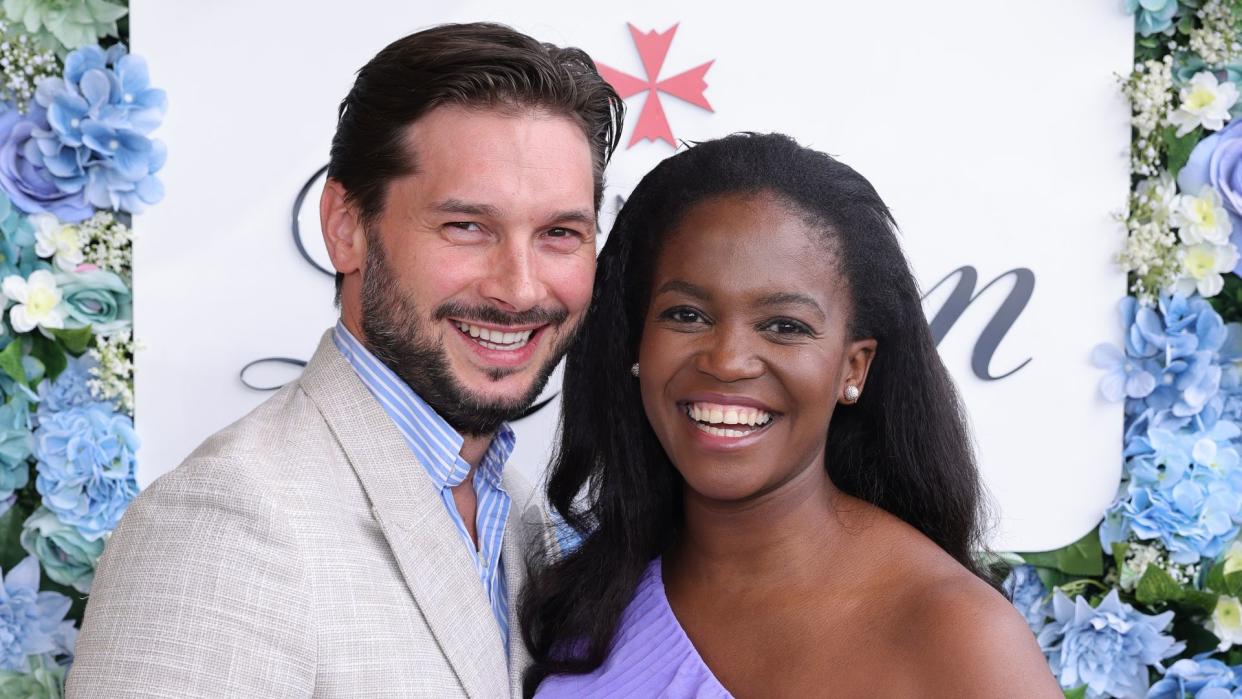 Pregnant Oti Mabuse with husband Marius Iepure posing with Champagne Lanson at The Championships at Wimbledon on