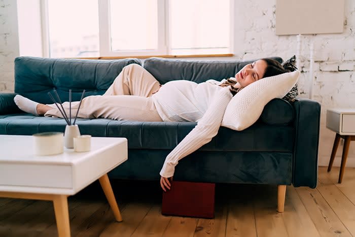 mujer sin energía tumbada en el sofá