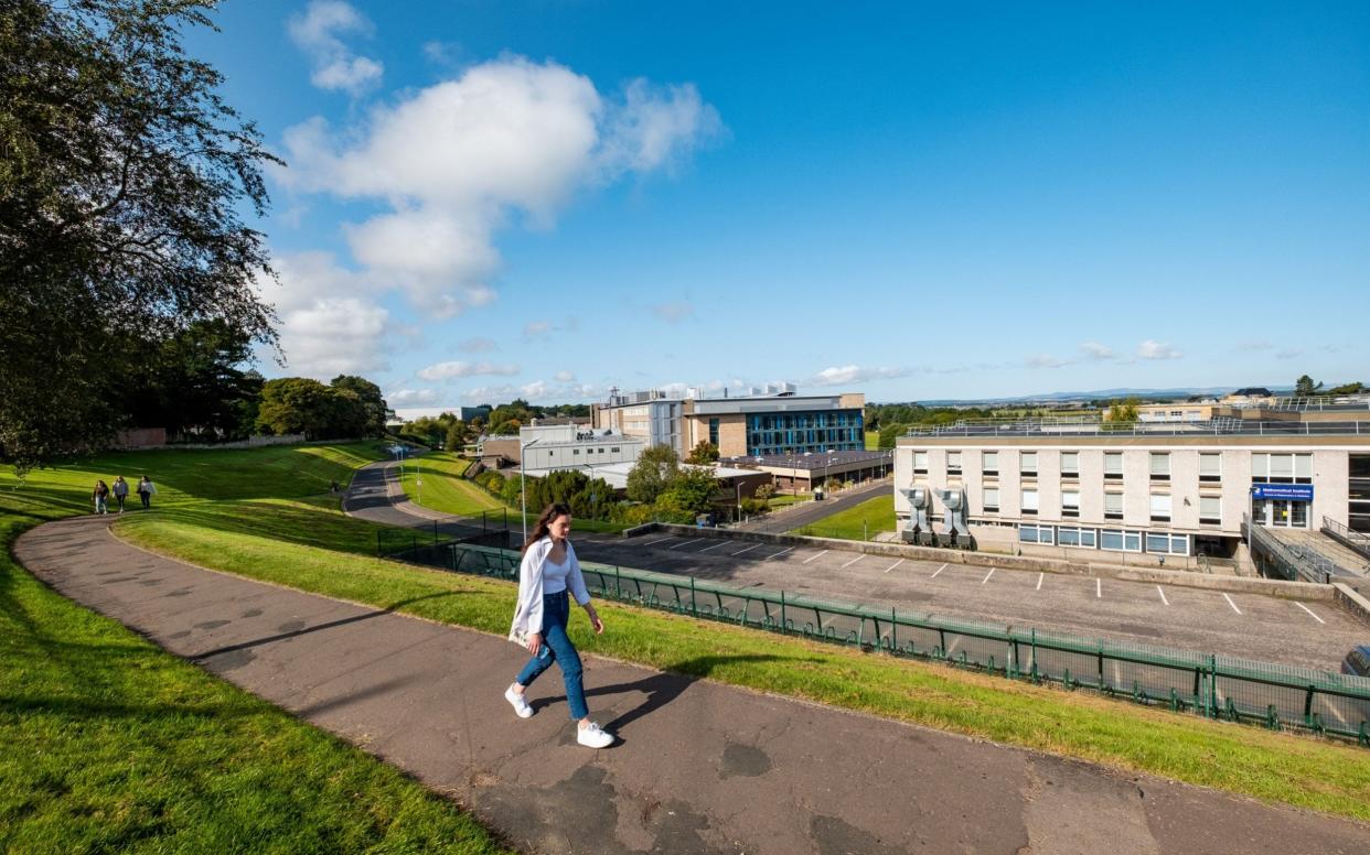 A student at St Andrews leaves the campus at the weekend, when a voluntary lockdown was in force - Stuart Nicol /Stuart Nicol photography