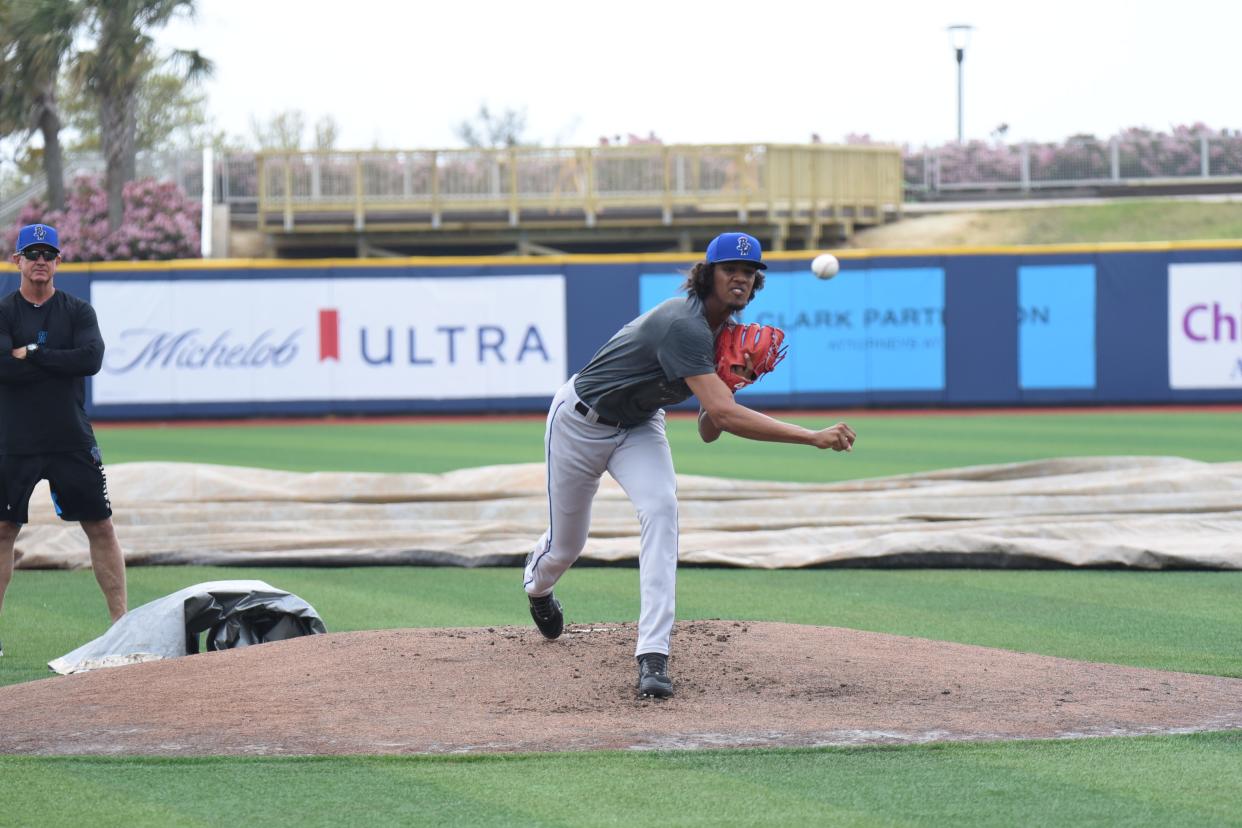 Blue Wahoos 18-year-old touted pitcher Eury Perez goes through a workout Tuesday at Blue Wahoos stadium as pitching coach Dave Eiland looks on.