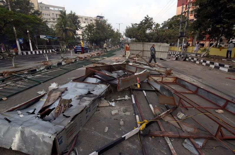 People walk past road blockades, laid by demonstrators on Thursday during a protest, after India's parliament passed a Citizenship Amendment Bill, in Guwahati