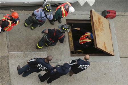 Metropolitan Transportation Authority (MTA) workers exit an emergency staircase after evacuating a derailed F train in Woodside, New York, May 2, 2014. REUTERS/Eduardo Munoz