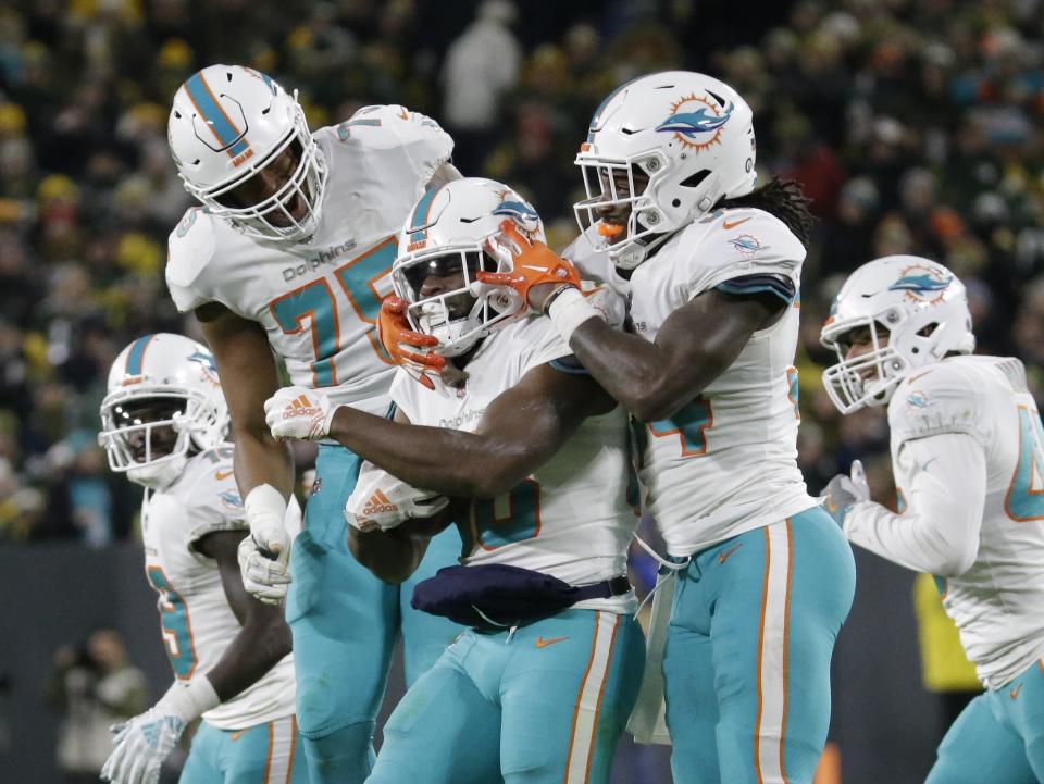 Miami Dolphins' Leonte Carroo is congratulated after recovering a blocked punt during the second half of an NFL football game against the Green Bay Packers Sunday, Nov. 11, 2018, in Green Bay, Wis. (AP Photo/Mike Roemer)