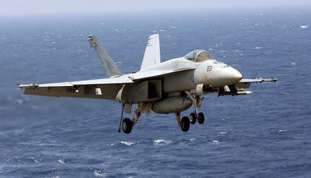 A U.S. Navy F18 fighter flies over the South China Sea as it prepares to land on the deck of USS Carl Vinson during a FONOPS (Freedom of Navigation Operation Patrol) in South China Sea, March 3, 2017. REUTERS/Erik De Castro