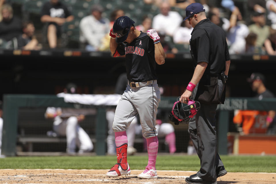 Cleveland Guardians' Andrés Giménez, left, steps on home plate after hitting a home run during the fourth inning of a baseball game against the Chicago White Sox, Sunday, May 12, 2024, in Chicago. (AP Photo/Melissa Tamez)
