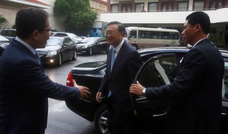 China's State Councilor Yang Jiechi (C) is greeted by Vietnamese ambassador to China Dang Minh Khoi (L) upon his arrival at the International Convention Center in Hanoi, Vietnam June 27, 2016. REUTERS/Kham