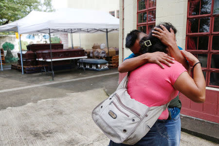 Bertilia Hernandez (L) who lost parents, brothers and nephews during the eruption of the Fuego volcano is comforted outside the morgue of Escuintla, Guatemala June 7, 2018. REUTERS/Luis Echeverria