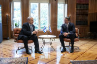 Greece's Prime Minister Kyriakos Mitsotakis, right, meets his Israeli counterpart Benjamin Netanyahu in Athens, Thursday, Jan. 2, 2020. The leaders of Greece, Israel and Cyprus will meet in Athens Thursday to sign a deal aiming to build a key undersea pipeline, named EastMed, designed to carry gas from new rich offshore deposits in the southeastern Mediterranean to continental Europe.(AP Photo/Yorgos Karahalis)