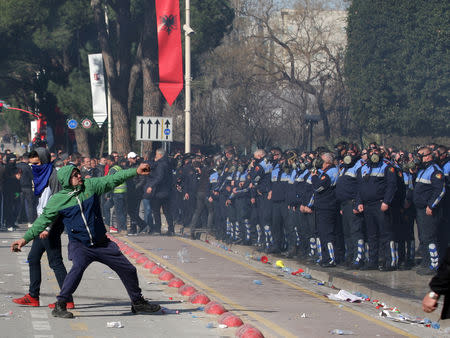 A supporter of the opposition party hurls stones during an anti-government protest in front of the office of Albanian Prime Minister Edi Rama in Tirana, Albania February 16, 2019. REUTERS/Florion Goga