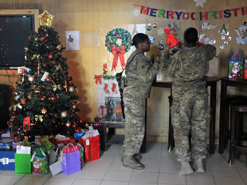 oldiers with the NATO-led International Security Assistance Force (ISAF) are socialise near decorations during a special meal on Christmas Day at a military base in Kabul on December 25, 2013.