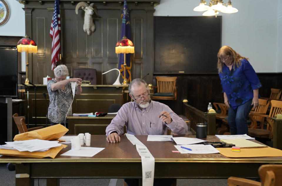 FILE - Esmeralda County Commissioner Ralph Keyes, center, works on a hand recount of votes with others, June 24, 2022, in Goldfield, Nev. An AP survey shows the majority of candidates running this year for the state posts that oversee elections oppose the idea of hand counting ballots, a laborious and error-prone process that has gained favor among Republicans who have been inundated with unfounded voting machine conspiracy theories. (AP Photo/John Locher, File)