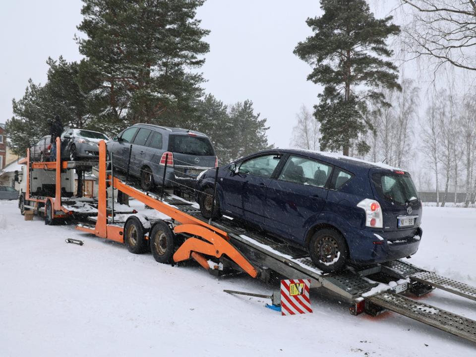 Eight cars in Latvia being transported to Ukraine on a trailer
