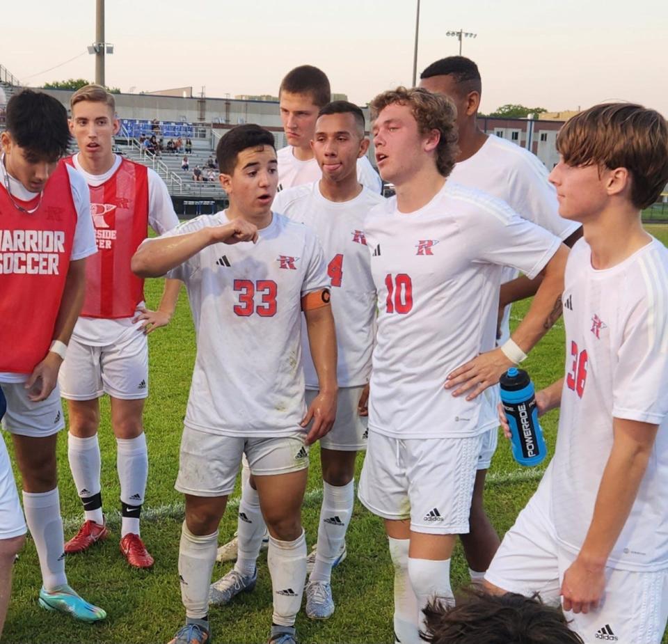 Riverside's Fabian Menendez (33) talks to his teammates before the start of Tuesday's second half at Eastside.