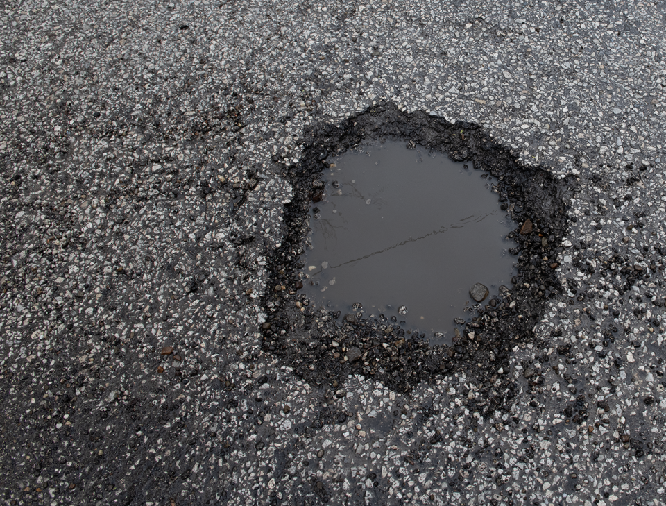 A pothole awaits repair on Mingo Trail in Springfield Township. The Summit County community's road maintenance program could lose its funding if voters do not pass a levy in November.