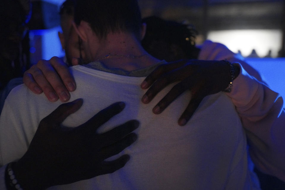 Aaron Dews and Jonathan Diggs place hands Noah Officer as they pray together at The Cove, a pop-up, 18-and-up Christian nightclub, on Saturday, Feb. 17, 2024, in Nashville, Tenn. The Cove was started last year by seven Black Christian men in their 20s who sought to build a thriving community and a welcoming space for young adults outside houses of worship. (AP Photo/Jessie Wardarski)