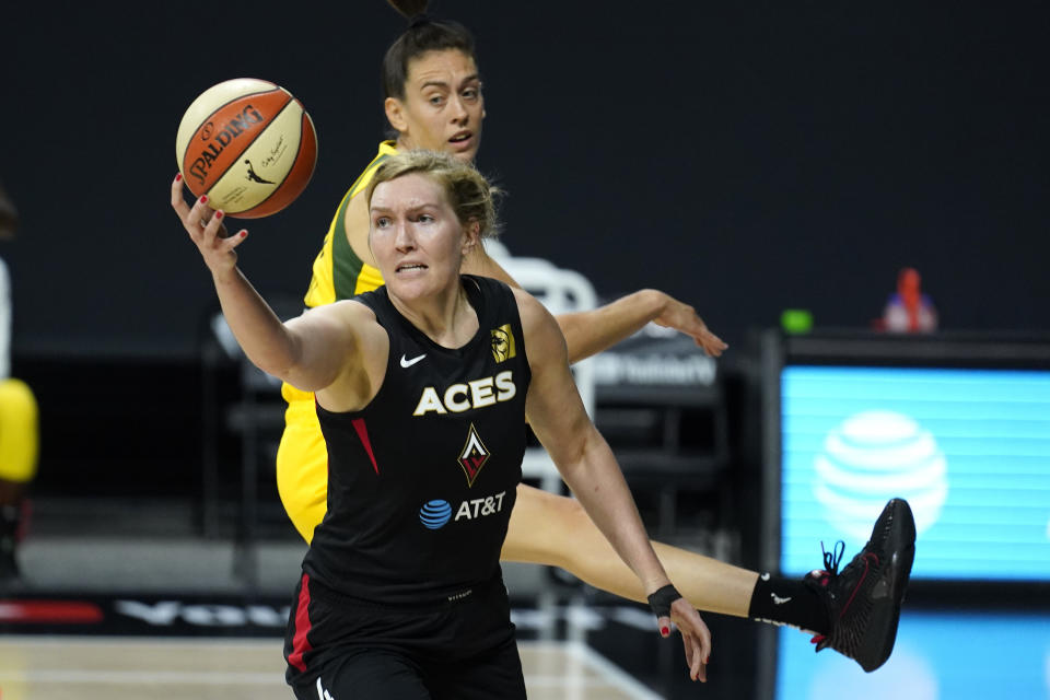 Las Vegas Aces center Carolyn Swords (4) grabs a rebound in front of Seattle Storm forward Breanna Stewart (30) during the first half of Game 1 of basketball's WNBA Finals Friday, Oct. 2, 2020, in Bradenton, Fla. (AP Photo/Chris O'Meara)