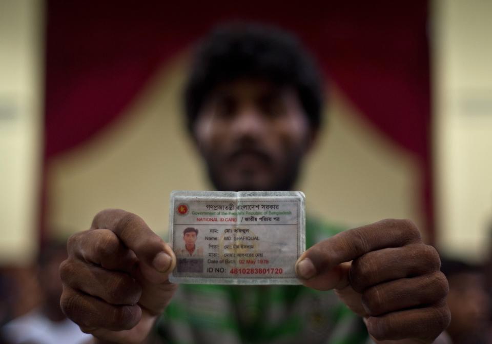 Bangladeshi migrant Md Shafiqual shows his Bangladeshi identification card at the Police headquarters in Langkawi on May 11, 2015, after landing up on the Malaysian shores earlier in the day.   (MANAN VATSYAYANA/AFP/Getty Images)