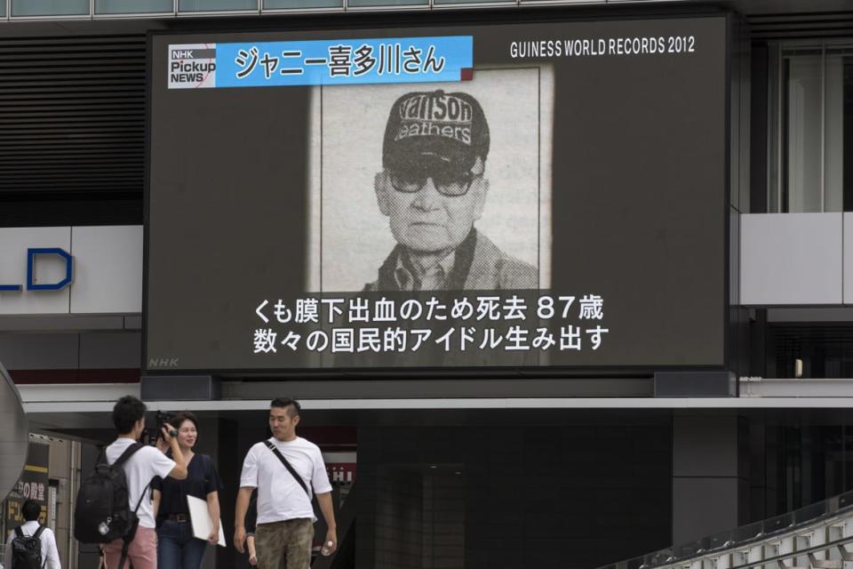 <div class="inline-image__caption"><p>Pedestrians walk past a big screen showing images of Johnny Kitagawa in a news program on July 10, 2019 in Tokyo, Japan. Johnny Kitagawa, president and founder of Johnny & Associates, a Japanese talent agency that produced a number of popular male idols died of stroke at the age of 87 on July 9, 2019.</p></div> <div class="inline-image__credit">Yuichi Yamazaki/Getty Images</div>