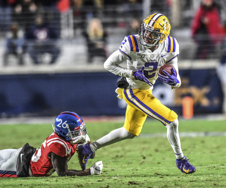 LSU wide receiver Justin Jefferson (2) eludes Mississippi defensive back Jalen Julius (26) during an NCAA college football game Saturday, Nov. 16, 2019, in Oxford, Miss. (Bruce Newman/Oxford Eagle via AP)