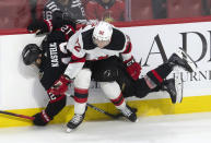 New Jersey Devils left wing Tomas Nosek (92) collides with Ottawa Senators center Mark Kastelic (12) along the board during third-period NHL hockey game action in Ottawa, Ontario, Saturday, April 6, 2024. (Adrian Wyld/The Canadian Press via AP)