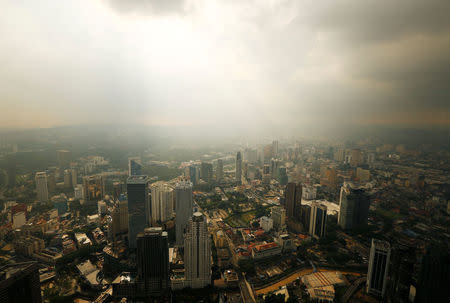 A rain storm clears over central Kuala Lumpur, Malaysia August 16, 2014. REUTERS/Olivia Harris/File Photo