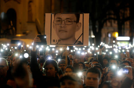 Demonstrators light up their mobile phones as they take part in a protest rally marking the first anniversary of the murder of the investigative reporter Jan Kuciak and his fiancee Martina Kusnirova in Bratislava, Slovakia, February 21, 2019. REUTERS/David W. Cerny