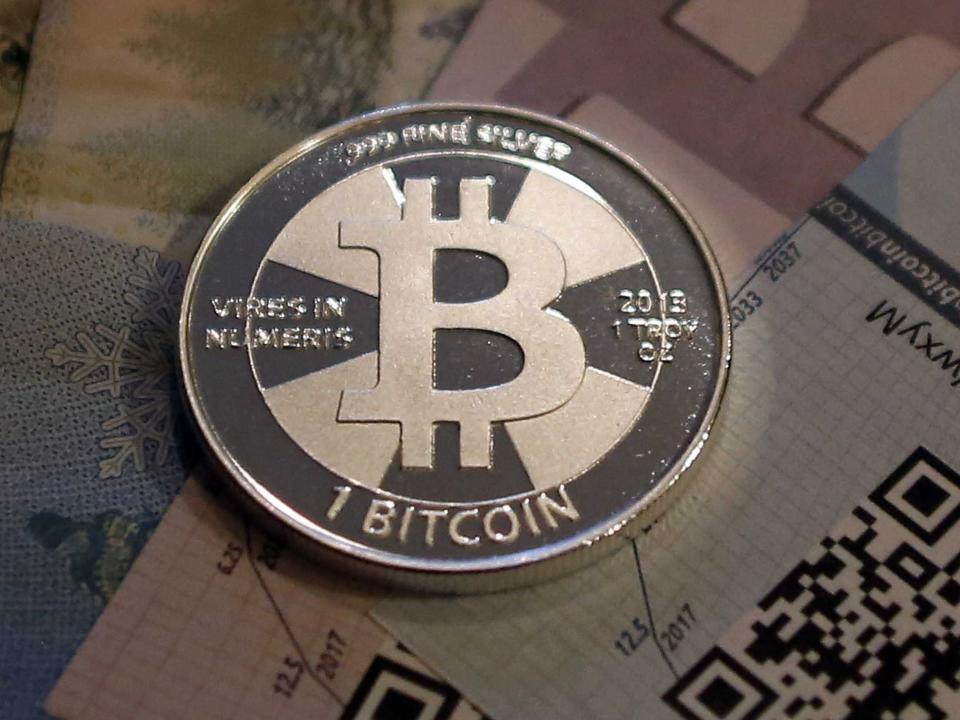 One of Bitcoin enthusiast Mike Caldwell's coins in this photo illustration at his office in Sandy, Utah, September 17, 2013. Bitcoins, touted by some experts as the future of money, gained in prominence during Europe's financial crisis as more people questioned the safety of holding their cash in the bank. Cameron and Tyler Winklevoss, currently making headlines with plans to launch a Bitcoin fund, said on Tuesday that they could see the digital currency becoming a country's official money.