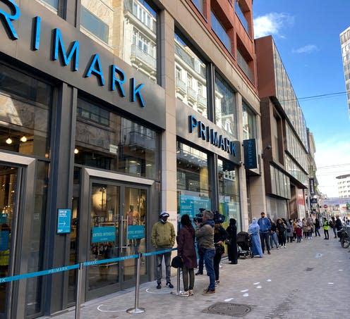 <span class="caption">Customers queue to enter Primark on May 11 last year, after lockdown was eased. </span> <span class="attribution"><a class="link " href="https://www.shutterstock.com/image-photo/clients-queue-enter-shops-rue-neuve-1728573688" rel="nofollow noopener" target="_blank" data-ylk="slk:Alexandros Michailidis/shutterstock;elm:context_link;itc:0;sec:content-canvas">Alexandros Michailidis/shutterstock</a></span>