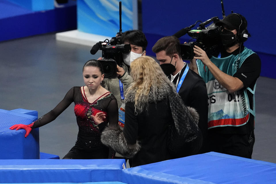 Kamila Valieva, of the Russian Olympic Committee, talks with her coach Eteri Tutberidze after the women's free skate program during the figure skating competition at the 2022 Winter Olympics, Thursday, Feb. 17, 2022, in Beijing. (AP Photo/Natacha Pisarenko)