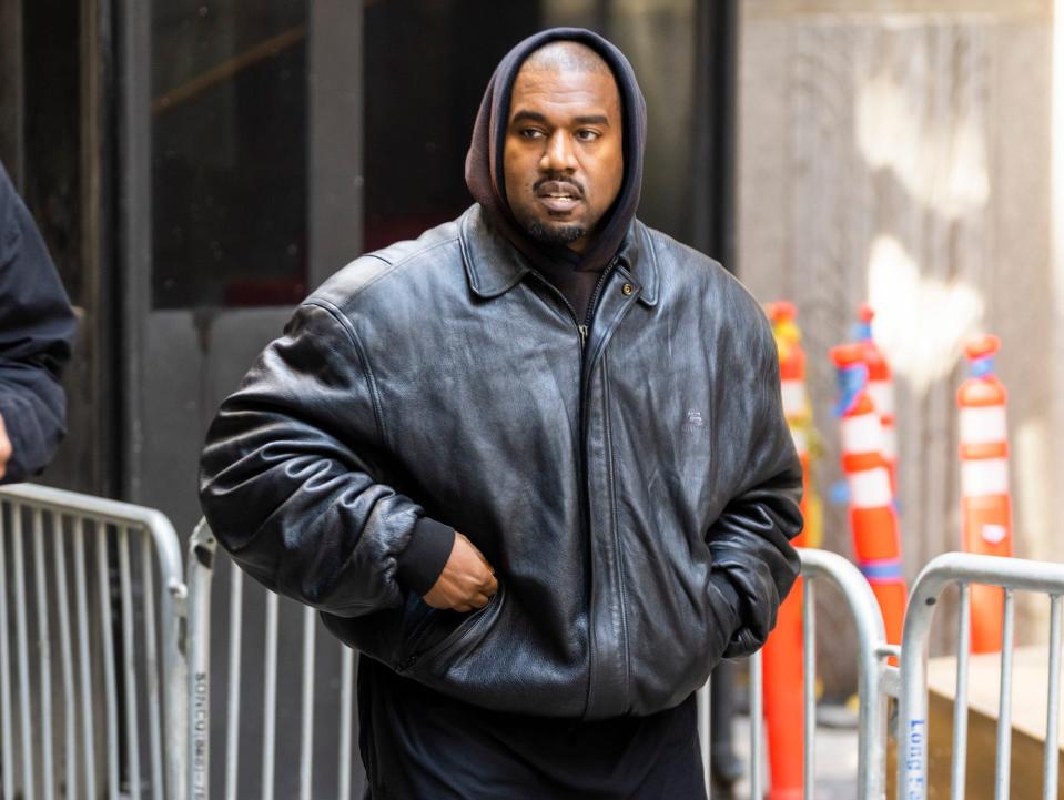 Kanye West wears black and attends the Balenciaga Spring 2023 Fashion Show at the New York Stock Exchange in May 2022.