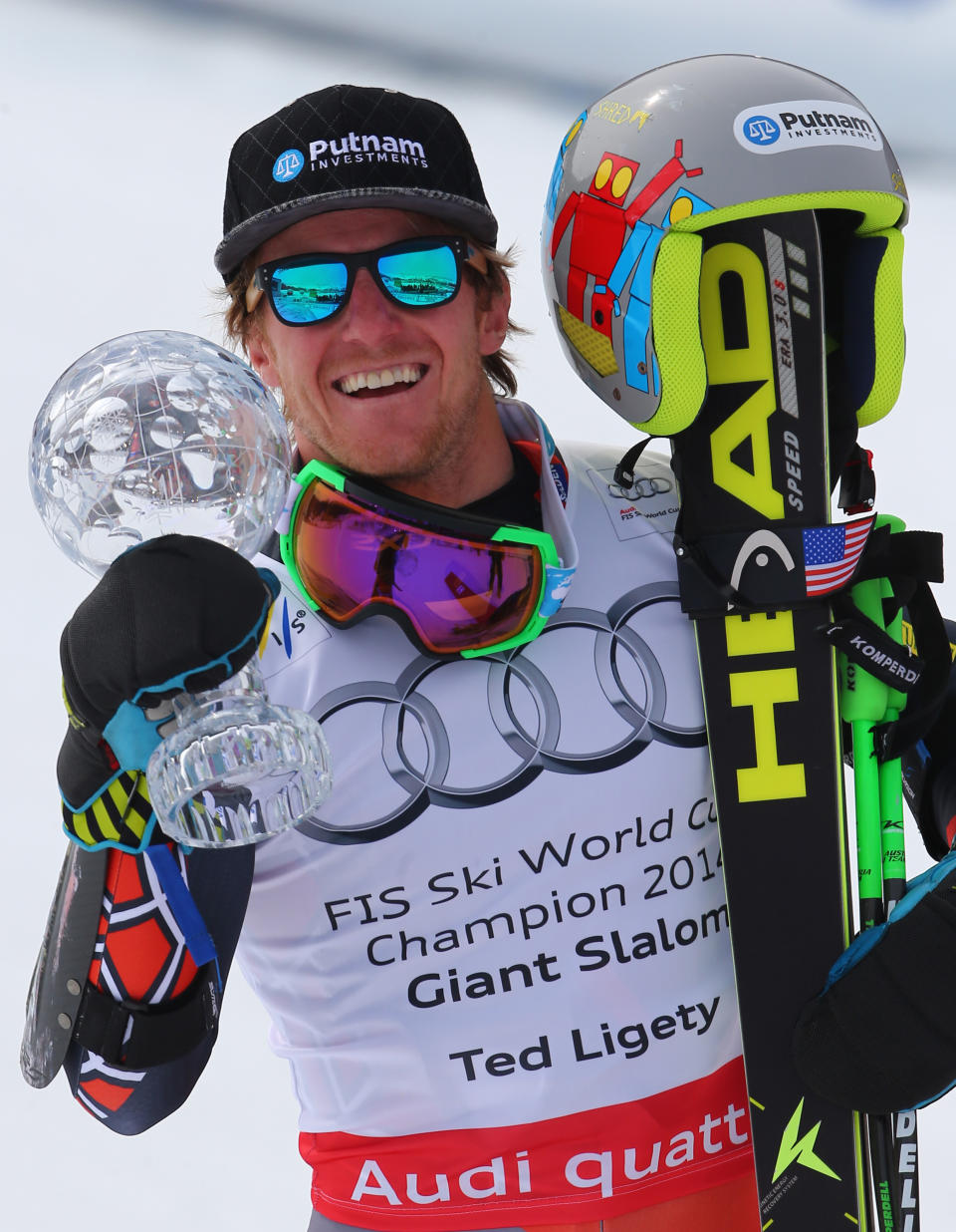 Ted Ligety, of the United States, holds up his trophy after winning an Alpine Ski men's giant slalom at the World Cup finals, in Lenzerheide, Switzerland, Saturday, March 13, 2013. (AP Photo/Marco Trovati)