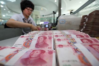 China's central bank on Tuesday unveiled a near two percent devaluation of the yuan, sending shock waves across international markets (AFP Photo/)