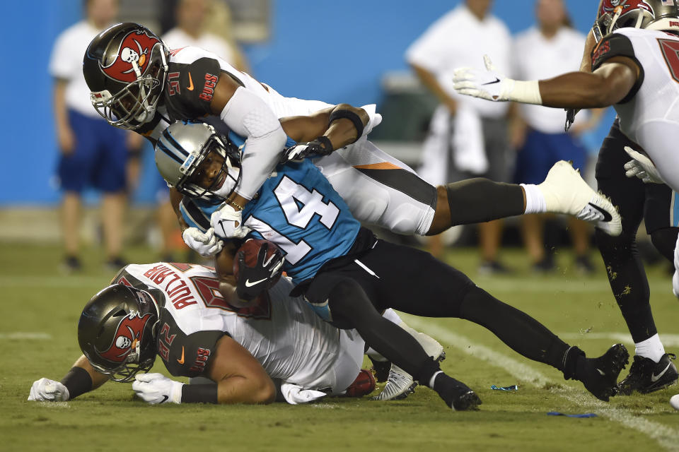 Tampa Bay Buccaneers linebacker Kevin Minter, top, and tight end Antony Auclair (82) tackle Carolina Panthers wide receiver Ray-Ray McCloud (14) during the first half of an NFL football game in Charlotte, N.C., Thursday, Sept. 12, 2019. (AP Photo/Mike McCarn)