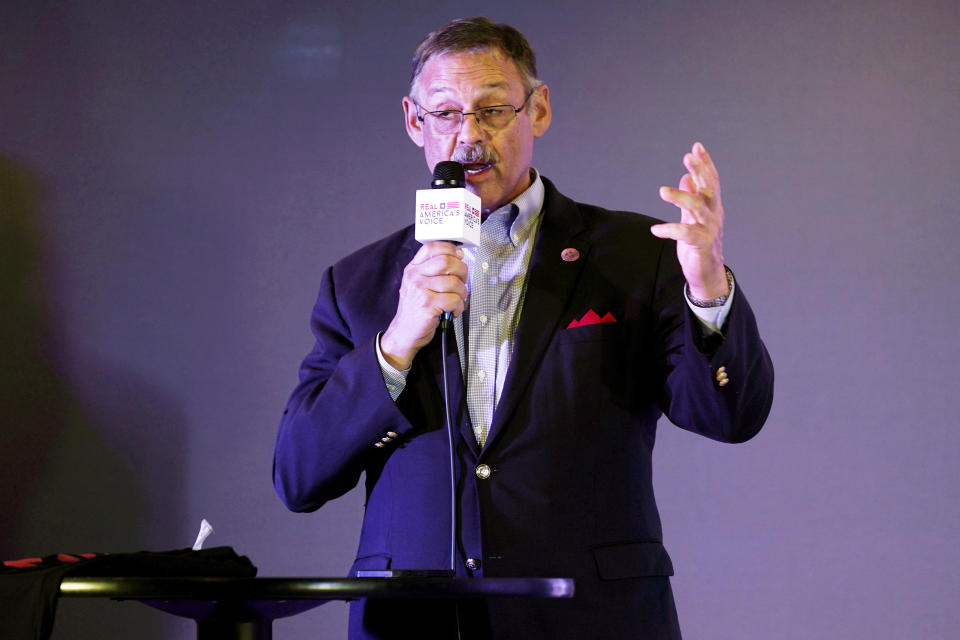 FILE - Rep. Mark Finchem, of Arizona, speaks during an election rally in Richmond, Va., on Oct. 13, 2021. A federal judge refused Friday, Aug. 26, 2022, to require that Arizona officials count ballots by hand in November, dismissing a lawsuit filed by the Republican nominees for governor, Kari Lake, and secretary of state, Finchem, based on false claims of problems with vote-counting machines. (AP Photo/Steve Helber, File)