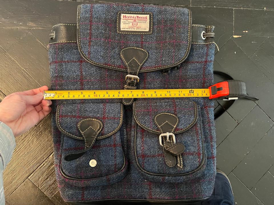 A rucksack with a tape measure laid on top of it measuring 35cm