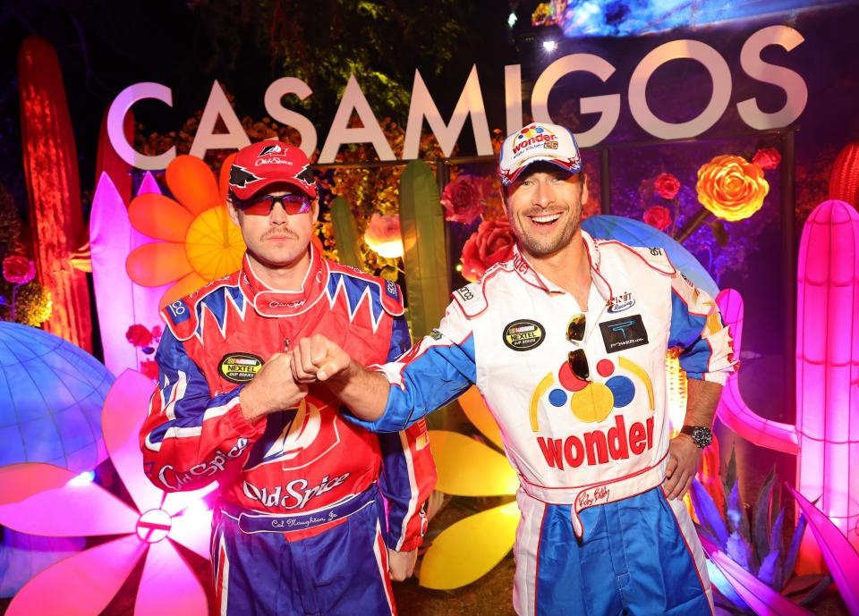 closeup of them in nascar driver jumpsuits at a party