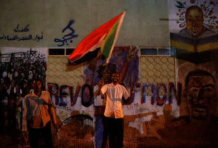 A Sudanese protester waves a national flag as he arrives a mass protest in front of the Defence Ministry in Khartoum, Sudan, April 21, 2019. REUTERS/Umit Bektas