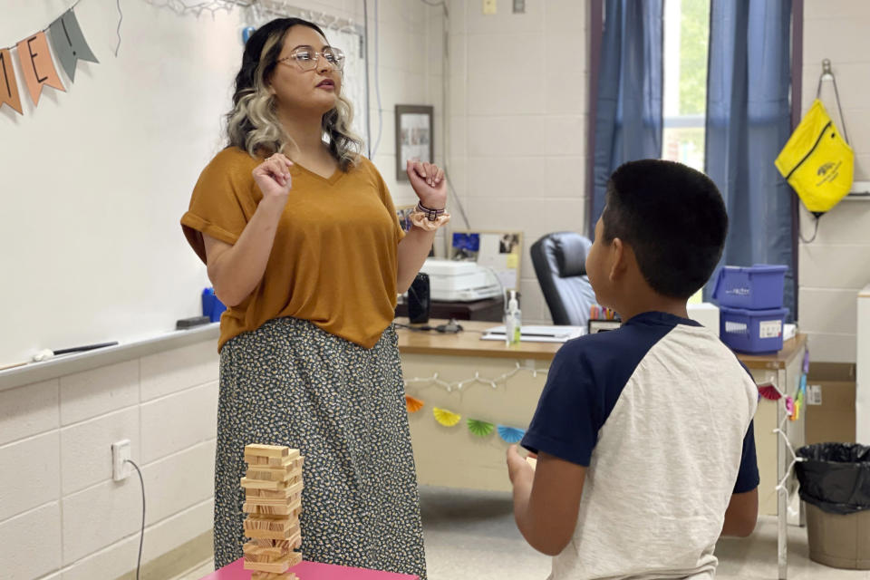 Katherine Alfaro works with students at Russellville Elementary School, in Russellville, Ala., Aug. 9, 2022. Alfaro is an aide for English Language Learner students, many of whom speak Spanish at home. Russellville schools have the highest percentage of English Language Learners of any district in the state, and officials there have invested in aides and teachers who know how to work with those students. (Rebecca Griesbach/AL.com via AP)