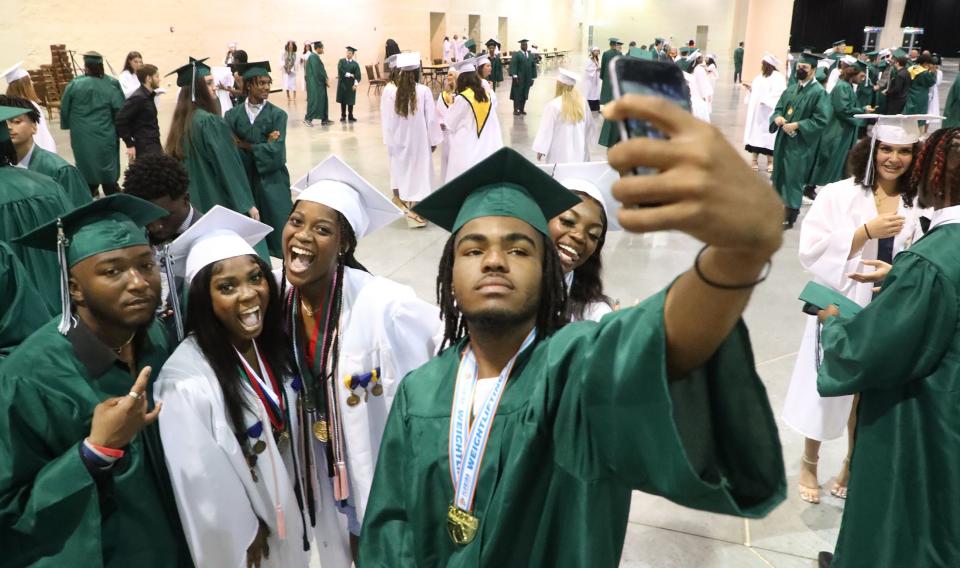 Flagler-Palm Coast High seniors take selfies as they wait for the start of their commencement exercises, Saturday, May 28, 2022, at the Ocean Center.