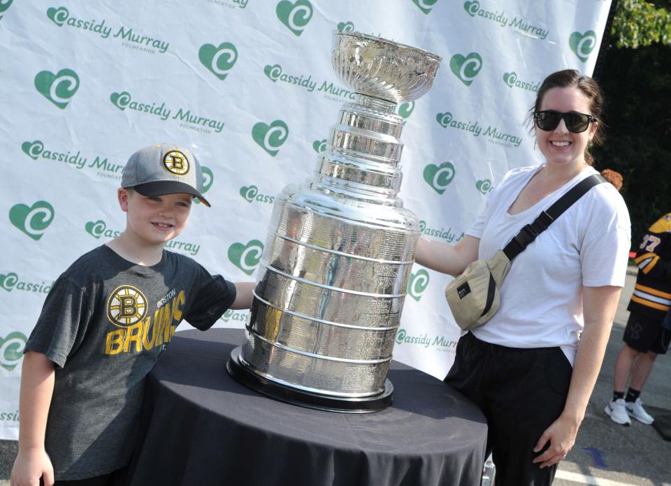 Owen McPhilemy, 6, of Canton, left, and his mom, Kara McPhilemy, stand with the Stanley Cup during the kickoff of the Cassidy Murray Foundation in Milton on Thursday, July 13, 2023.