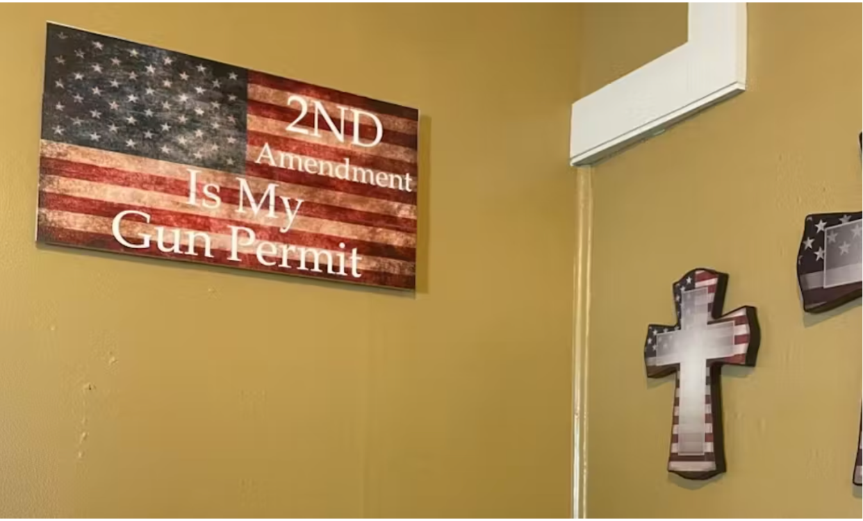 Gift shop shot with a sign that reads "The 2nd Amendment Is My Gun Permit" and other merchandise with American flags.