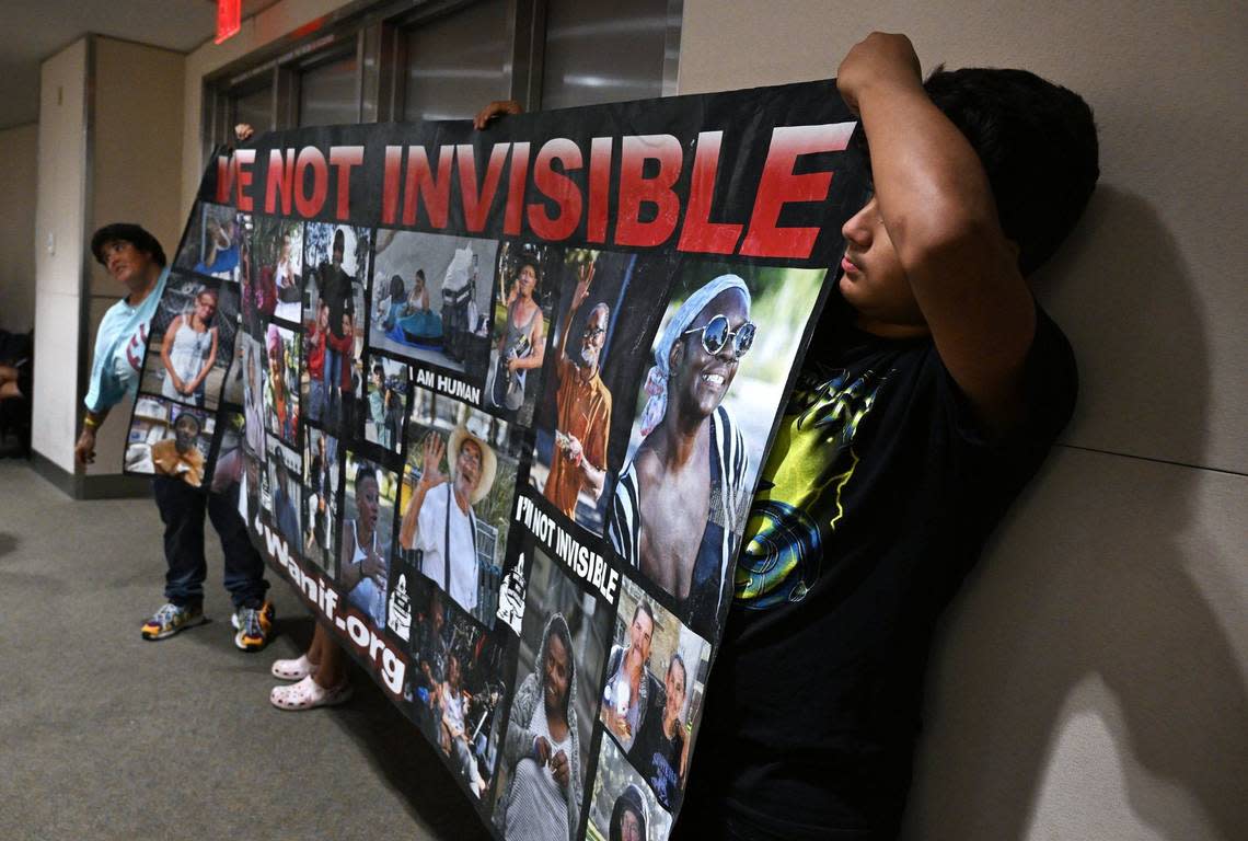 Advocates for the homeless hold a large banner at the rear of the City Council chamber before a special Fresno City Council meeting on a proposed ordinance banning homeless camps on Monday, July 29, 2024 in Fresno. The ordinance received final approval from the council on Aug. 15 and will take effect Sept. 15.