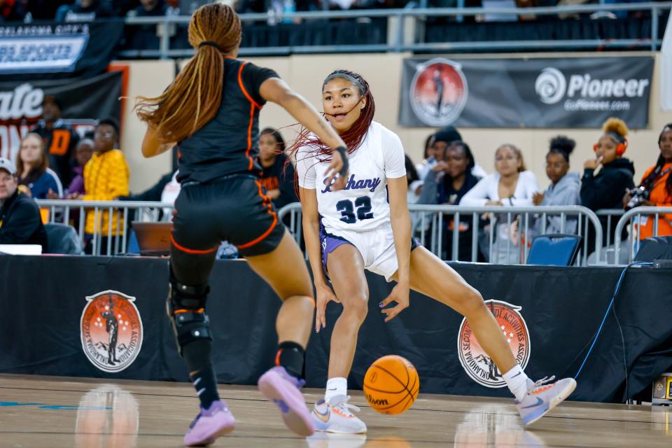 Bethany’s Keziah Lofton (32) dribbles during the Class 4A girls basketball state semifinals against Douglass on March 8 at State Fair Arena.