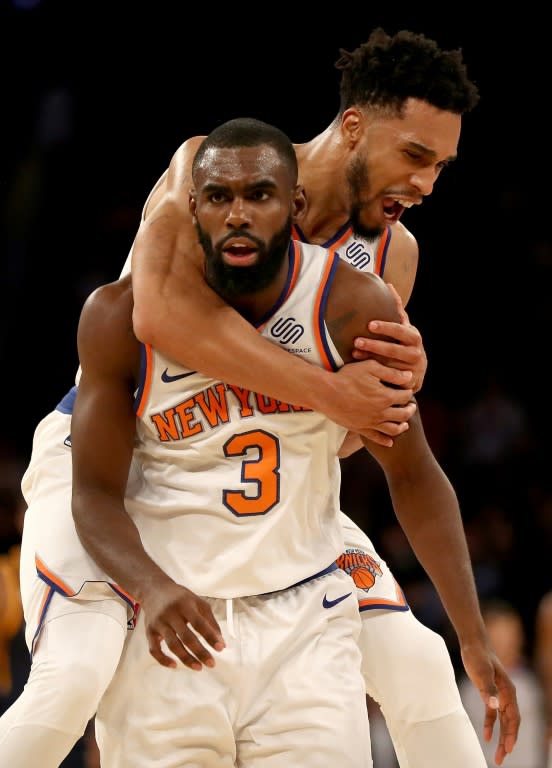 Tim Hardaway Jr. of the New York Knicks is congratulated by teammate Courtney Lee after Hardaway Jr. hit a three point shot in the final minutes of their game against the Utah Jazz, at Madison Square Garden in New York, on November 15, 2017